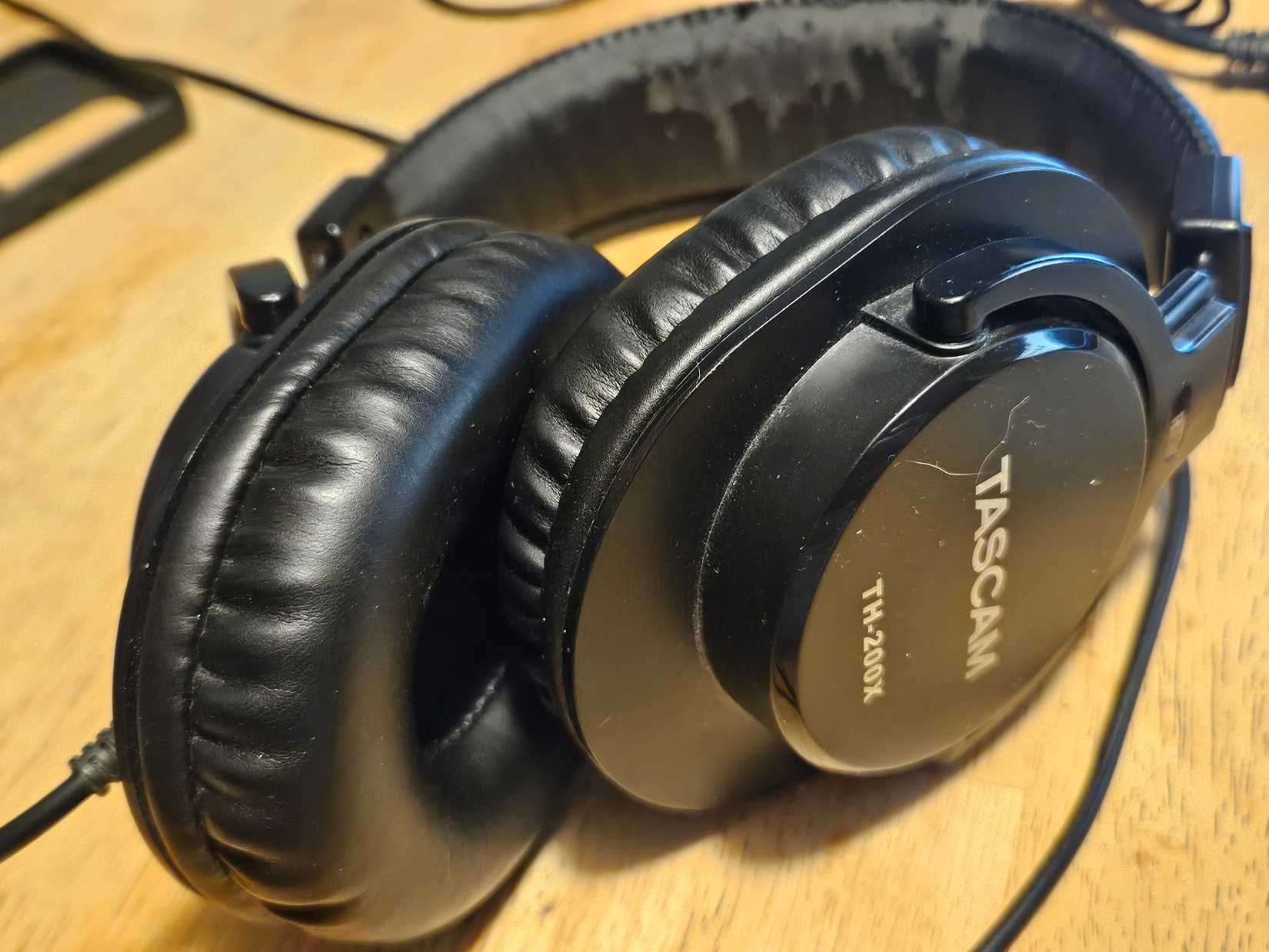 A pair of Tascam monitoring headphones on a table.