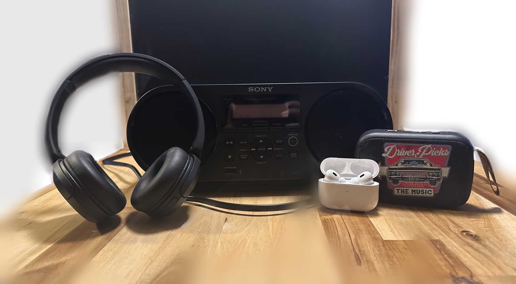 A speaker, AirPods, and several headphones.