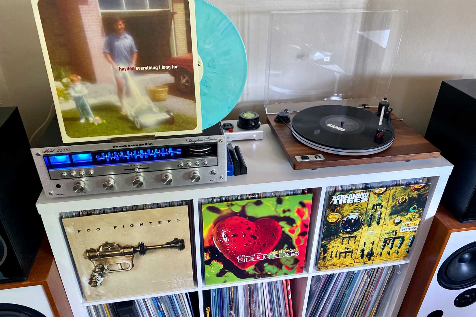 A turntable setup with a collection and various records displayed
