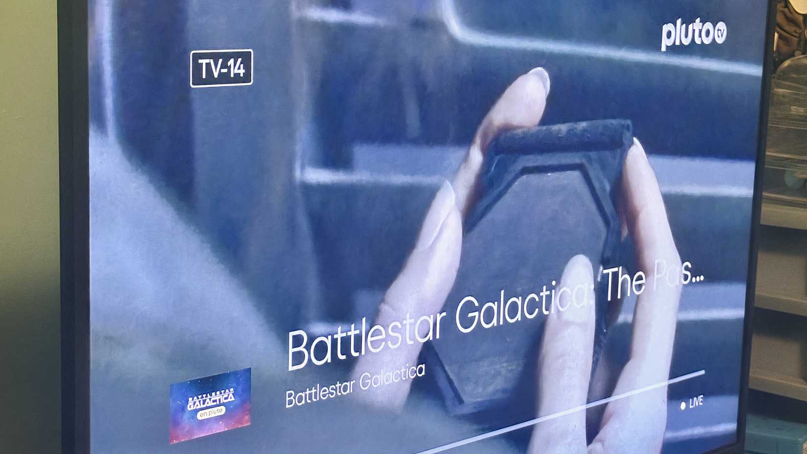 An episode of Battlestar Galactica is shown on a television screen after being broadcast from a Motorola phone.