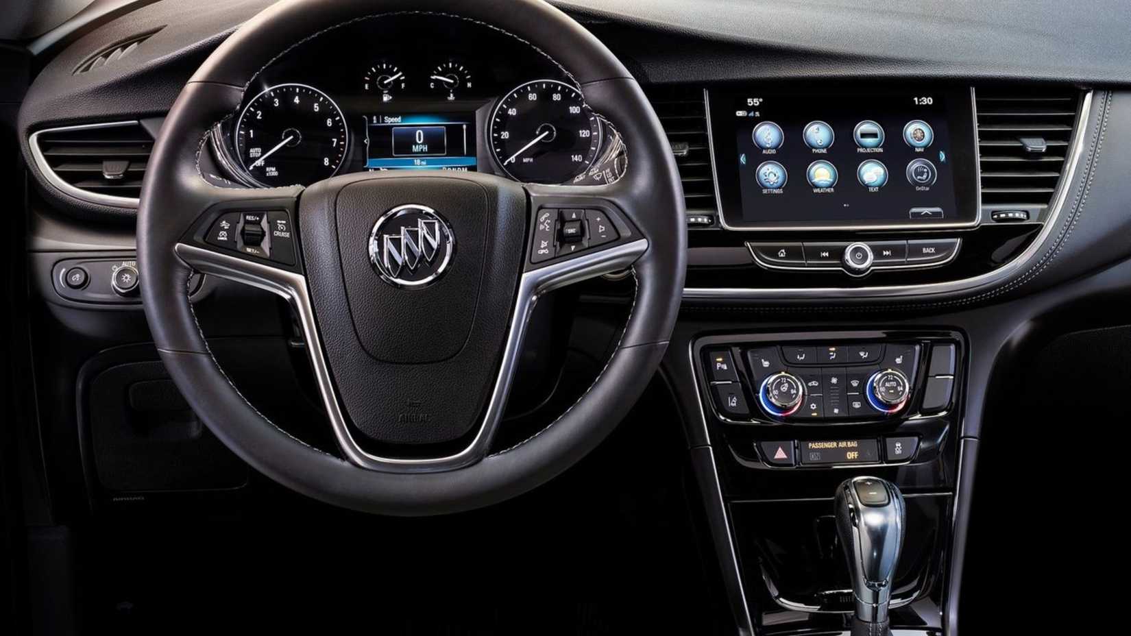 Close-up shot of the steering wheel and dashboard inside the cabin of a 2017 Buick Encore.