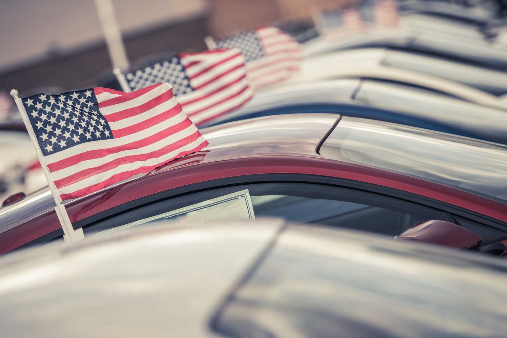 Cars on a car lot for a July 4th sale