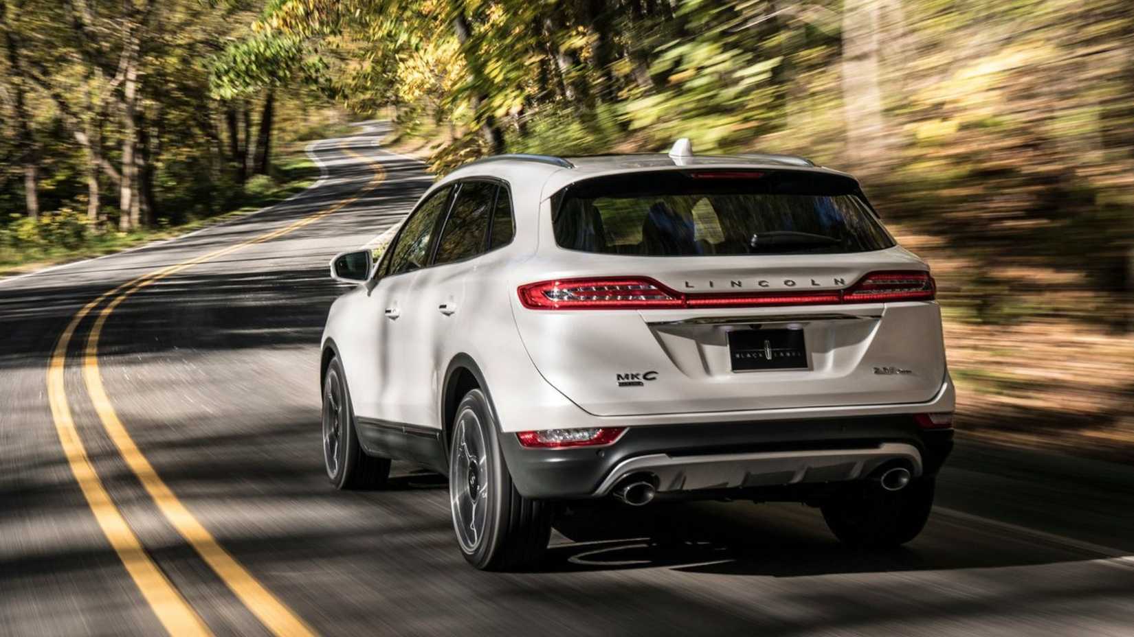 Dynamic rear 3/4 shot of a white 2019 Lincoln MKC.
