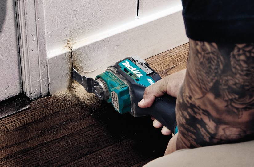 person using a Makita oscillating tool