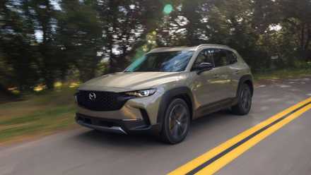Overlook Mercedes-Benz—This reasonably priced Korean Hybrid SUV feels strangely sumptuous Dynamic front 3/4 shot of a green 2023 Mazda CX-50.
