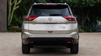 Static rear-end shot of a gold 2024 Nissan Rogue.