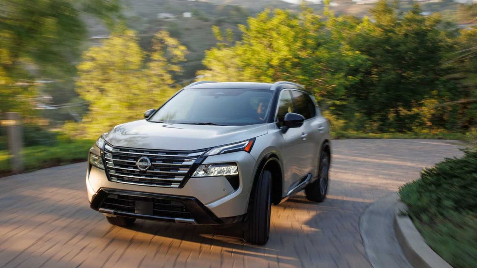 Dynamic front-end shot of a gold 2024 Nissan Rogue.