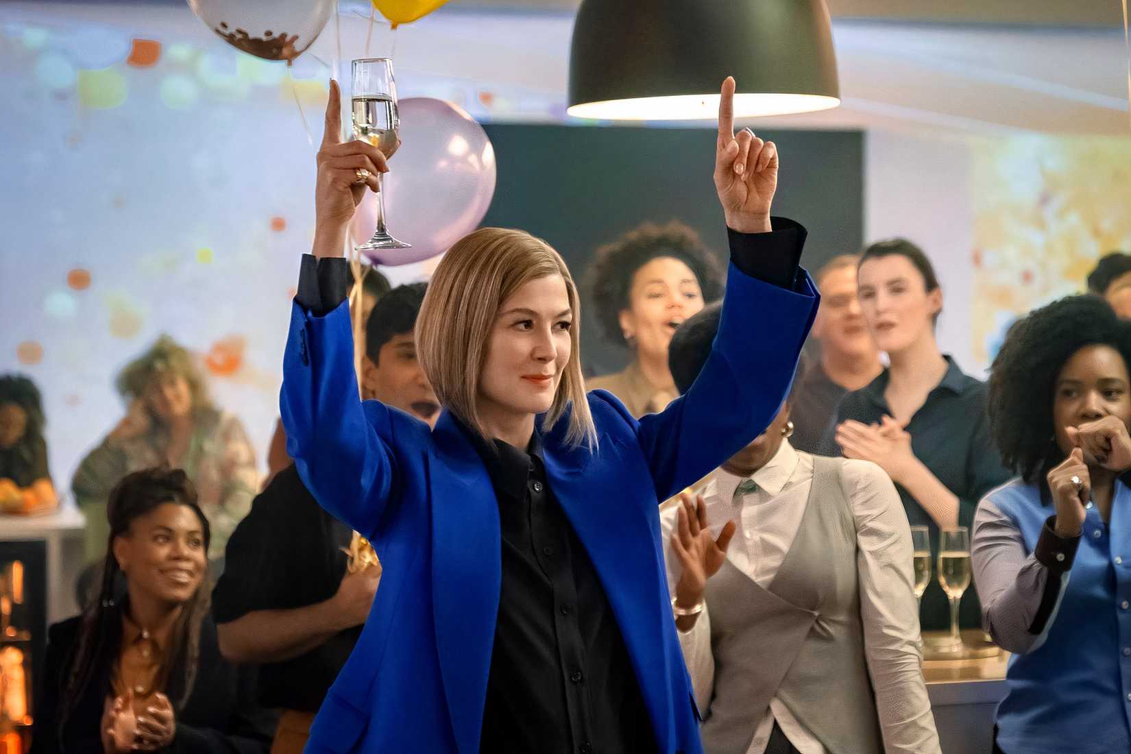 Rosamund Pike points her fingers in the air in Ladies First.