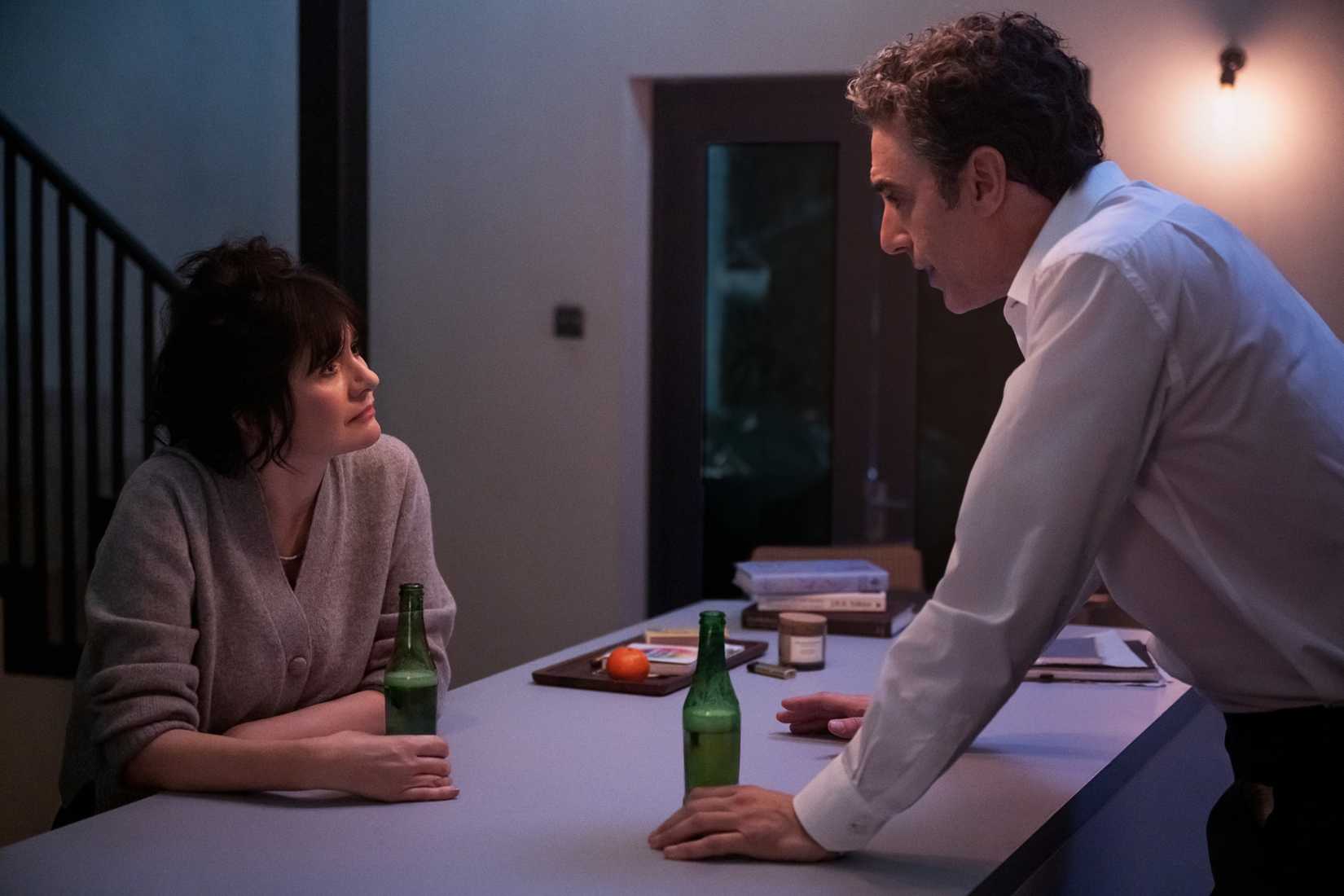 Sacha Baron Cohen stands at a table in Ladies First.