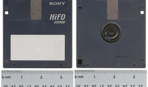 A Sony HiFD disk lying flat on a table with a measuring tape placed under it.