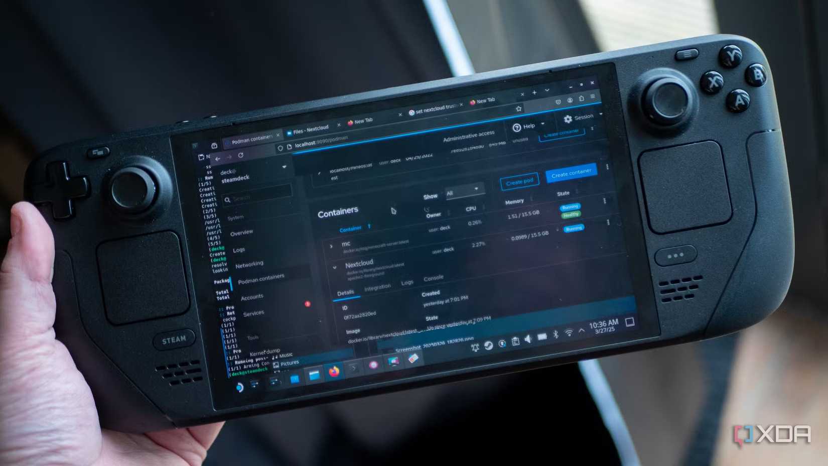 Hand holding a Steam Deck handheld gaming PC displaying a Linux container management interface on its screen.