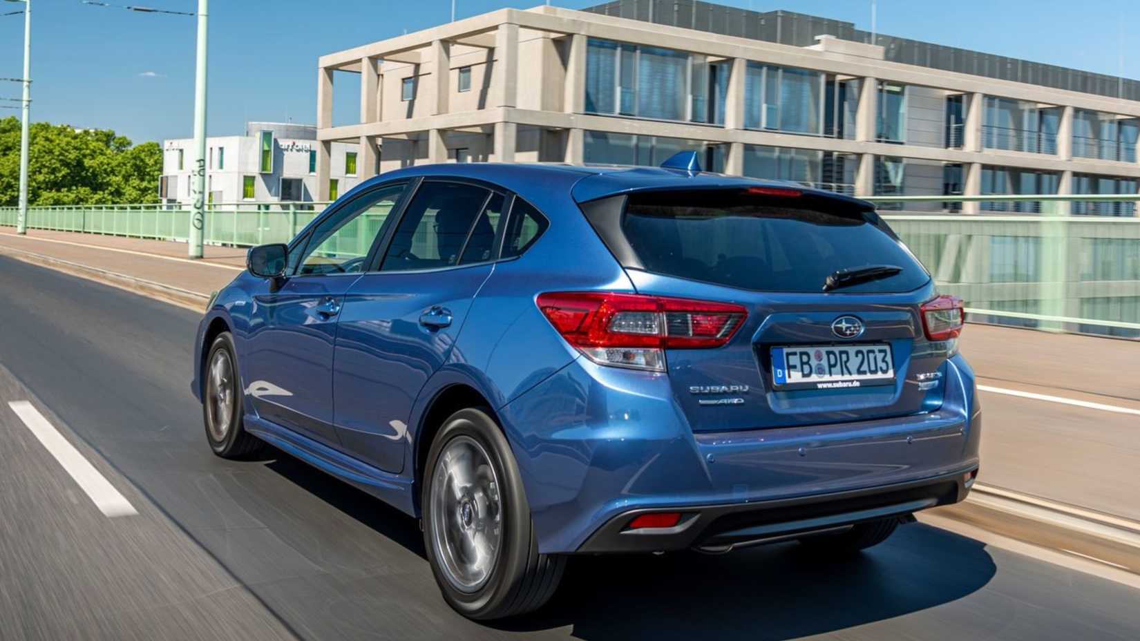 Dynamic 3/4 shot of the rear of a blue 2020 Subaru Impreza.