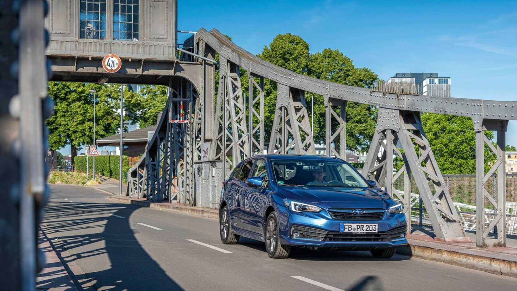 Dynamic front 3/4 shot of a blue 2020 Subaru Impreza.