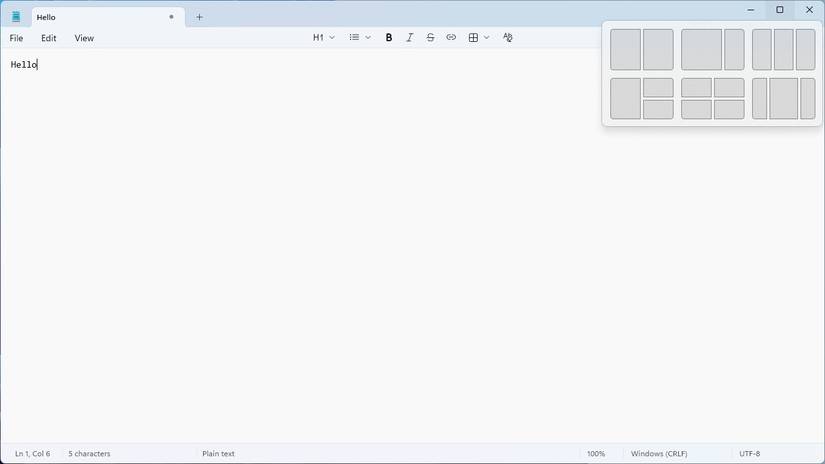 Notepad with the Windows Snap Layout window visible. 