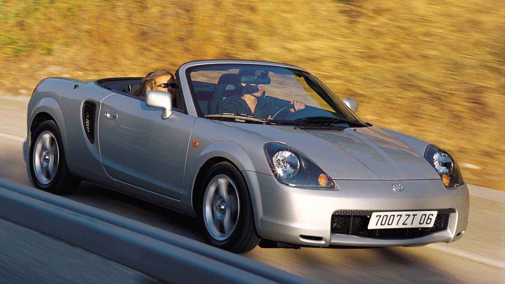 Dynamic front 3/4 shot of a silver 2000 Toyota MR2.
