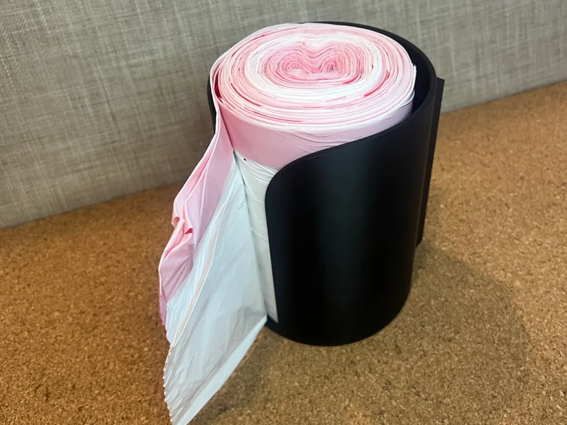 3D printed garbage bag holder with garbage bags inside.
