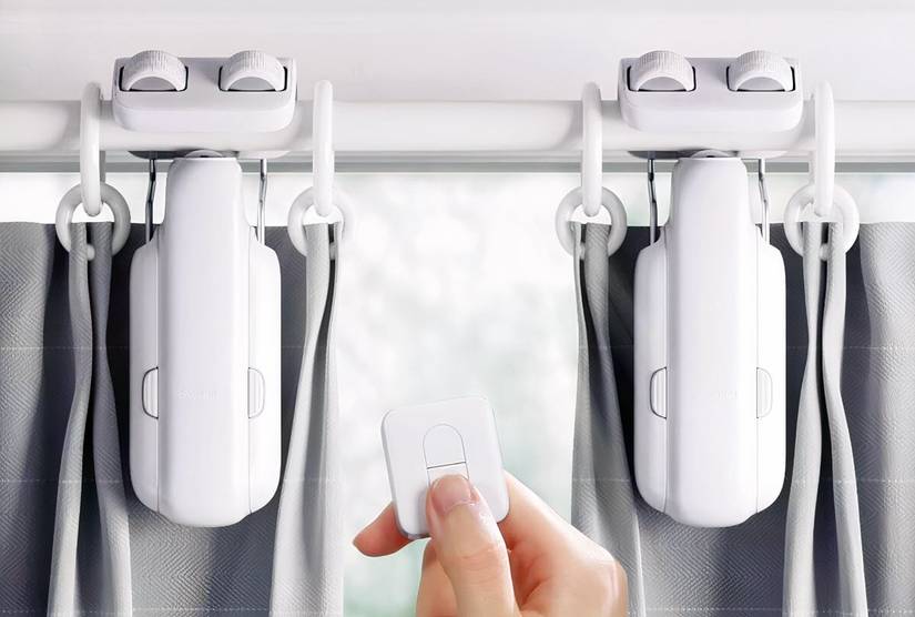 A person using the controller of the  SwitchBot 2025 Automatic Curtain Opener