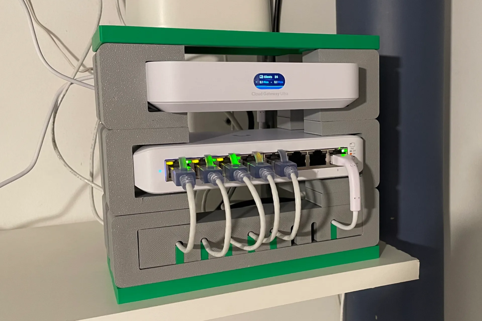 A 3D printed mini rack for UniFi networking gear like a Cloud Gateway and network switch.