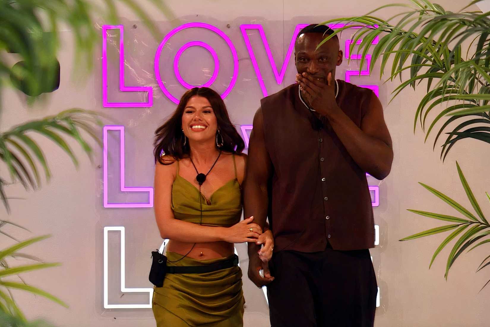 A woman and man walk into the villa in Love Island.