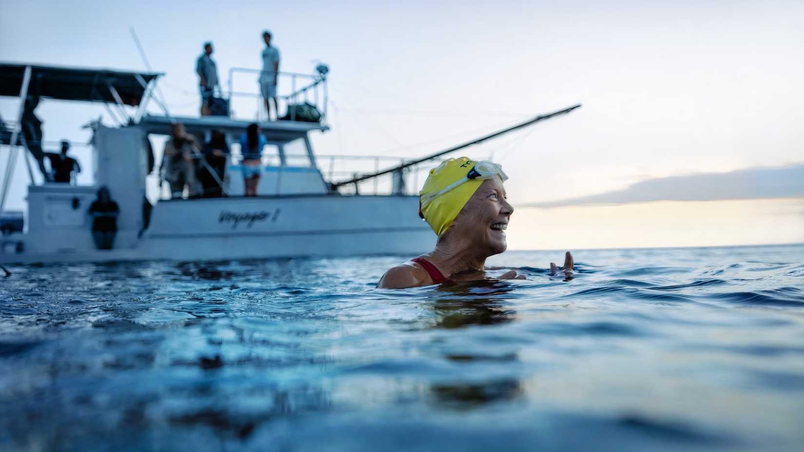 A woman smiles in the water in Nyad.