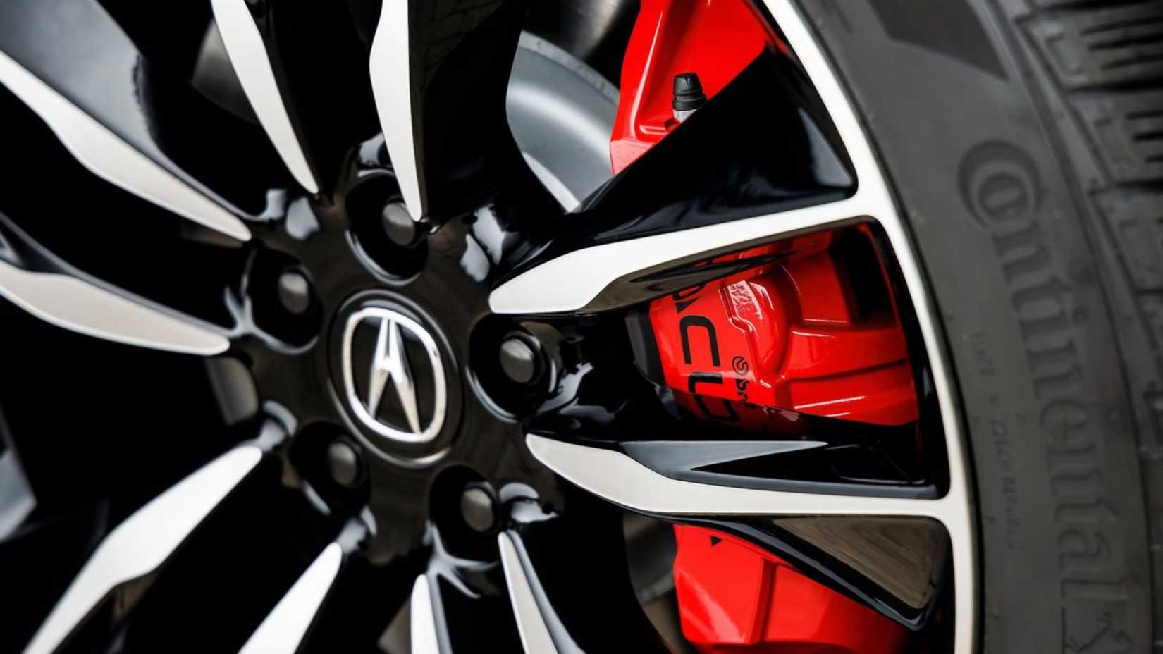 A close-up of the red brake caliper behind the permitted wheel on the 2022 Acura MDX Type S.
