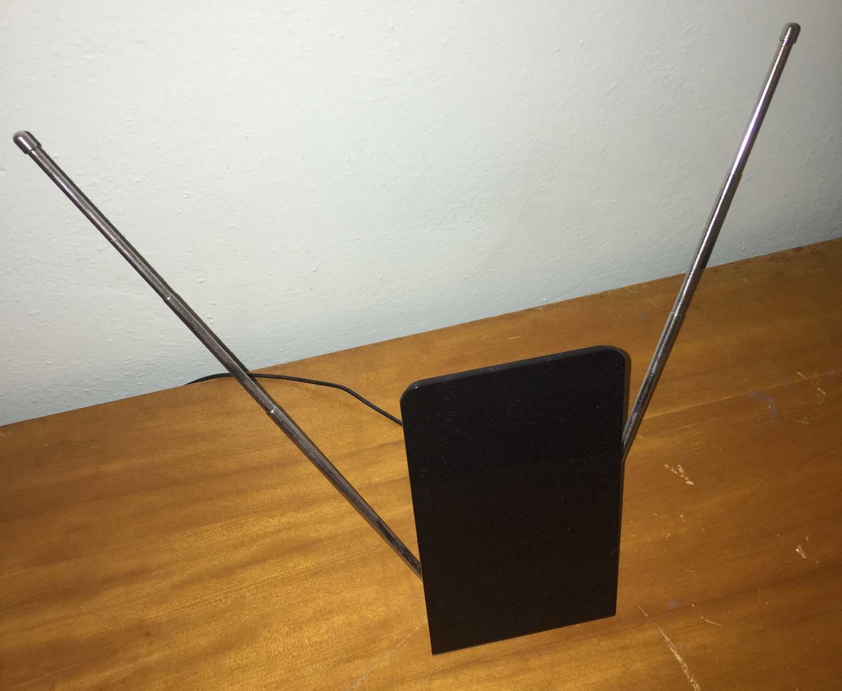 An over-the-air antenna sitting a table.