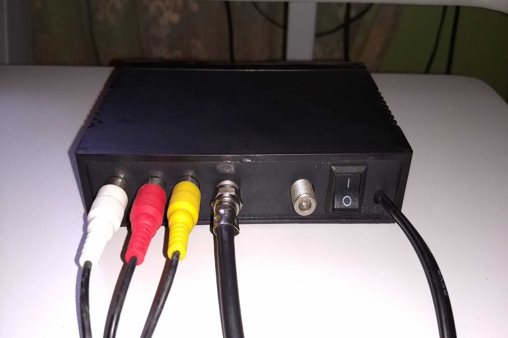 An RF modulator with one open caox and one connected to a cable.