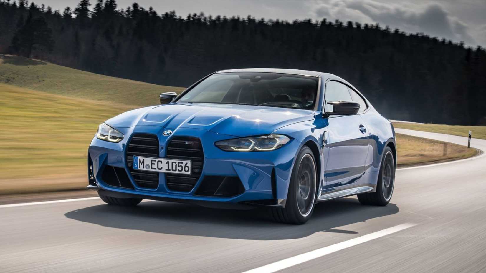 Dynamic front 3/4 shot of a blue 2022 BMW M4 Competition Coupe xDrive.