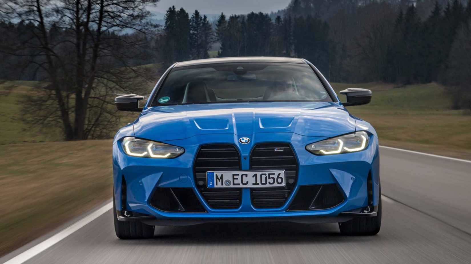 Dynamic front-end shot of a blue 2022 BMW M4 Competition Coupe xDrive.