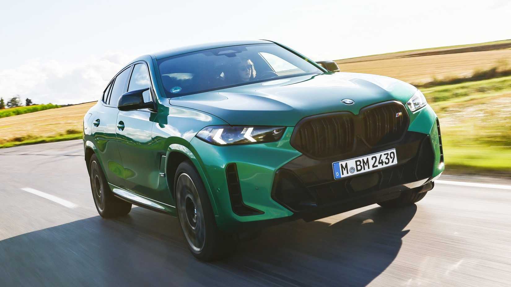 Front 3/4 action shot of a 2024 BMW X6