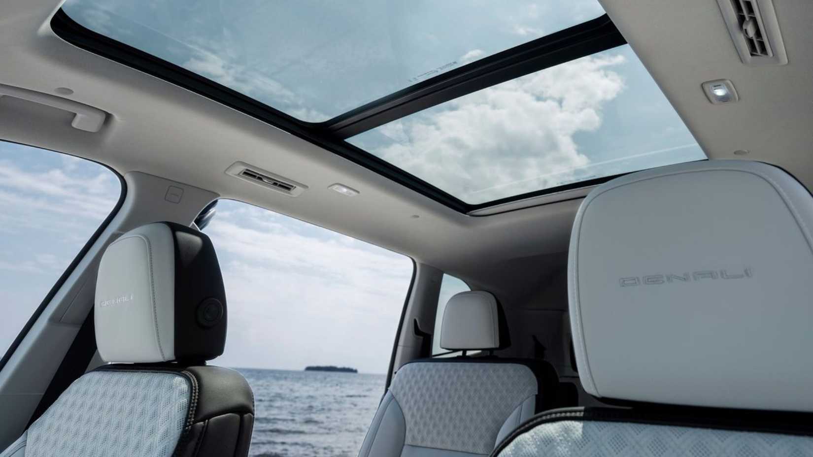 Shot of the interior and panoramic roof inside the cabin of a 2024 GMC Acadia.
