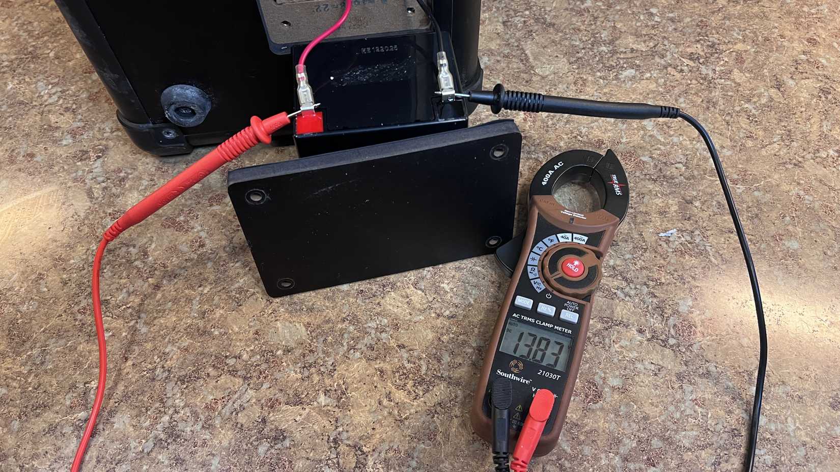 An image of a multimeter testing a rechargeable speaker