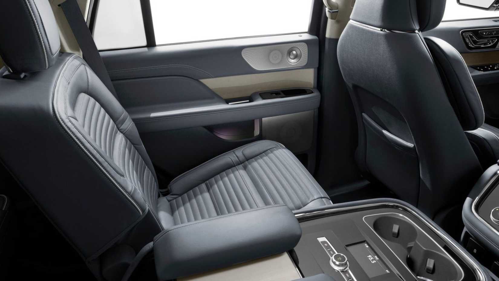 Shot of the second-row seats and center console inside the cabin of a 2018 Lincoln Navigator.