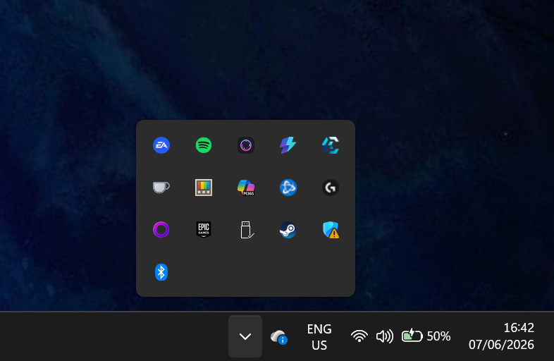 Windows notification area (system tray) expanded to show background apps and utilities running in the taskbar, including game launchers, audio tools, and system services.