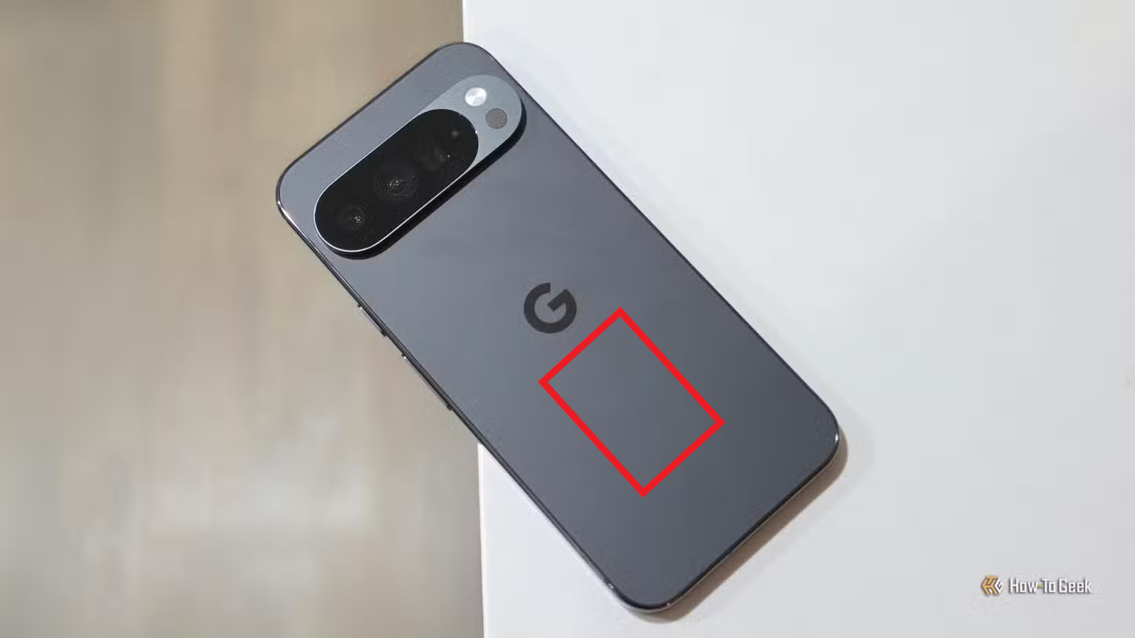 A Pixel 10 Pro with a highlighted square showing the optimal area to activate Quick Tap.