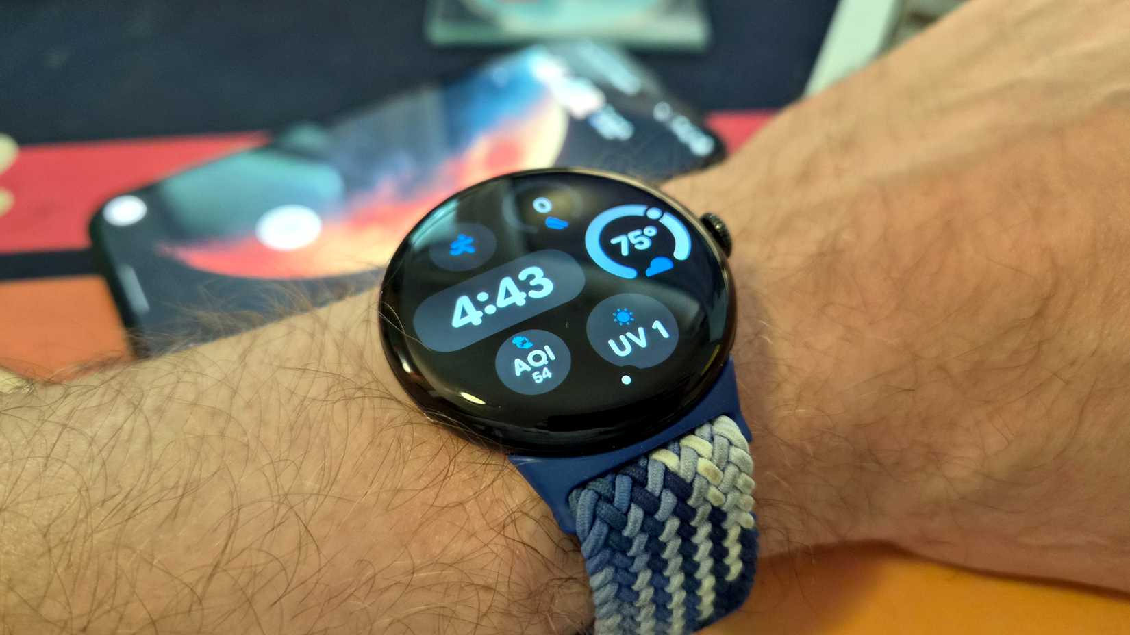 Pixel Watch with Pixel phone in background