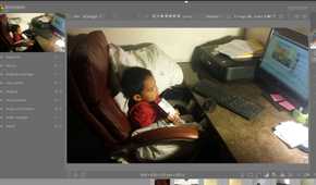 A child sitting and watching a computer in an image in darktable