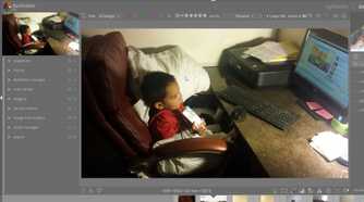 A child sitting and watching a computer in an image in darktable