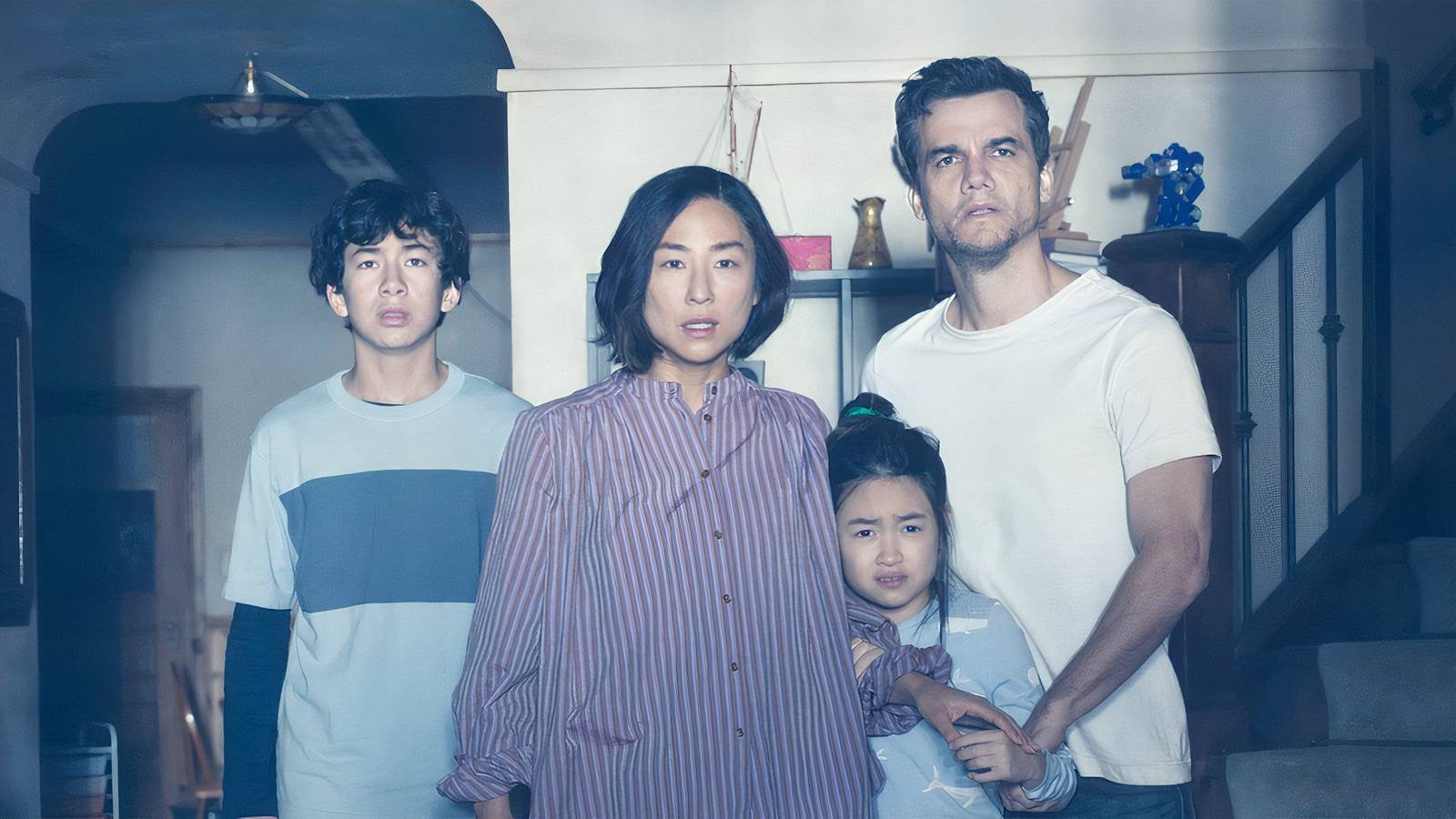 A family of four stare at the light in The Last House.