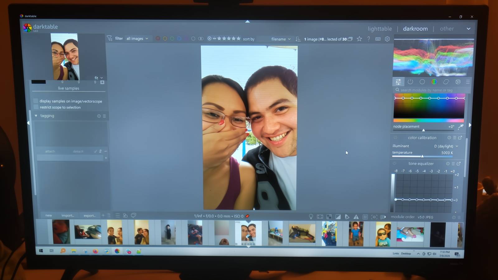 A man and woman smiling in Darktable.