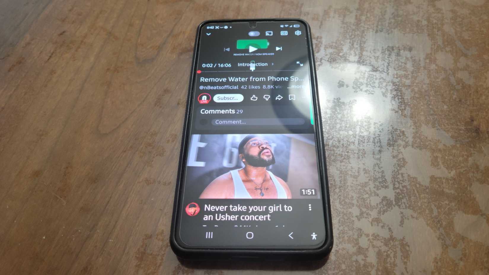 A phone about to play a sound that will get water out of it