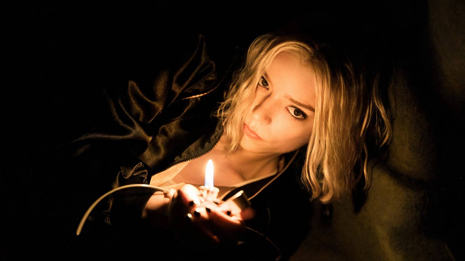 Anya-Taylor Joy holds up a match in Lucky.