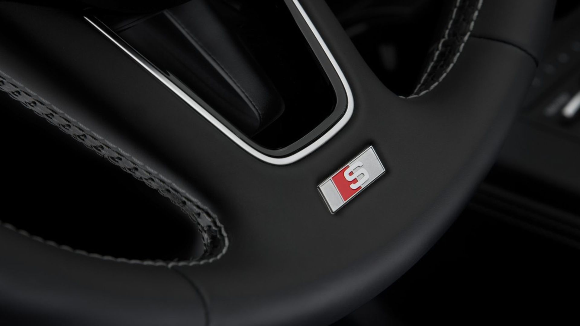 Close-up shot of the detailing on the steering wheel of a 2017 Audi S4.