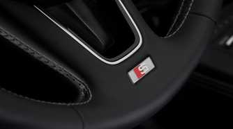Close-up shot of the detailing on the steering wheel of a 2017 Audi S4.