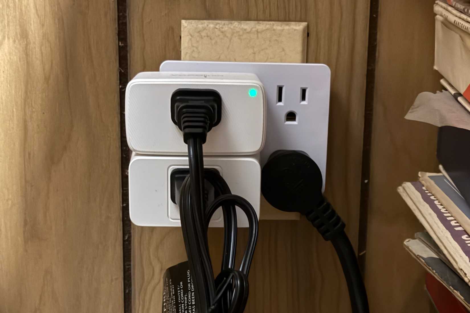 Two smart plugs taking over four outlets in an outlet expander.