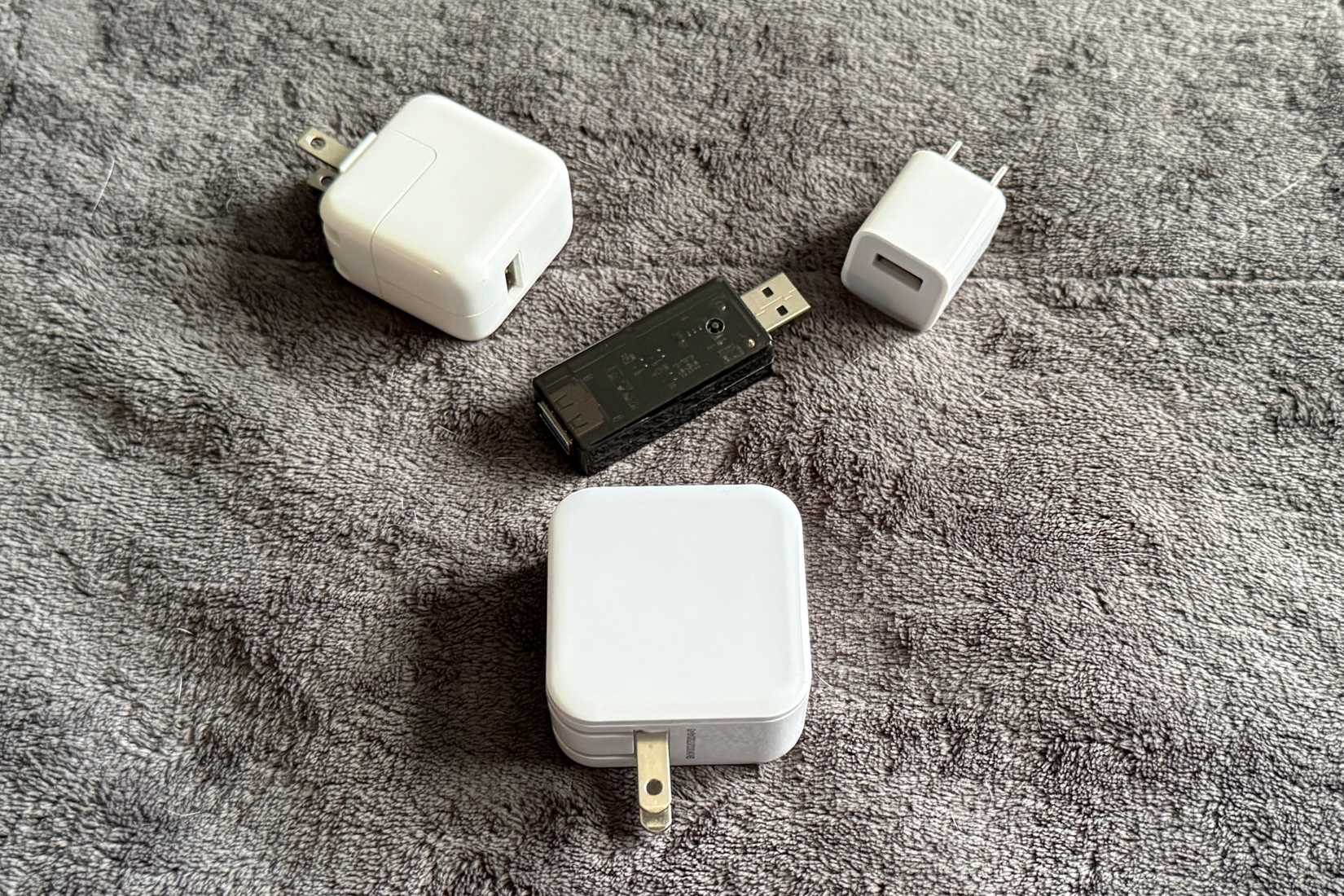Smart USB surrounded by standard USB power bricks.