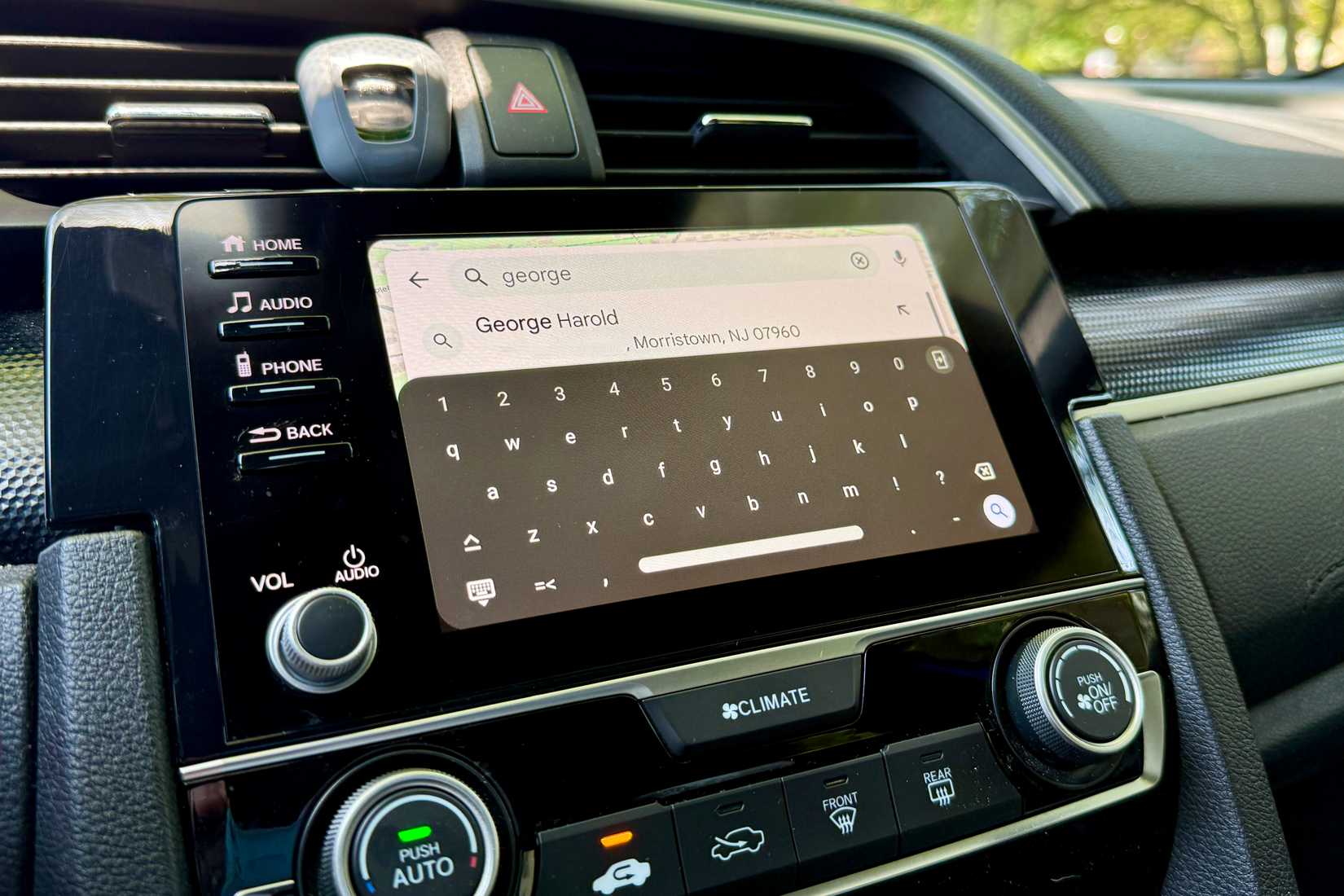 Typing in a person's name for directions in Google Maps with Android Auto.