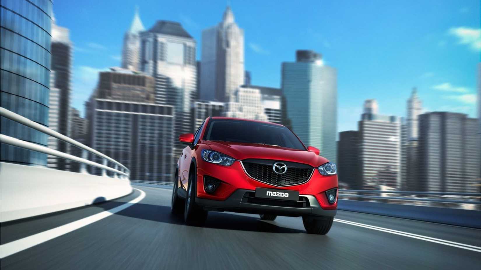 Dynamic front-end shot of a red 2013 Mazda CX-5.