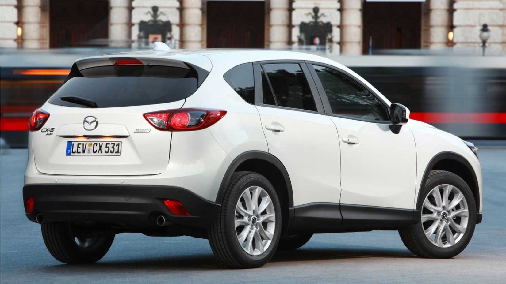 Static rear 3/4 shot of a white 2013 Mazda CX-5.