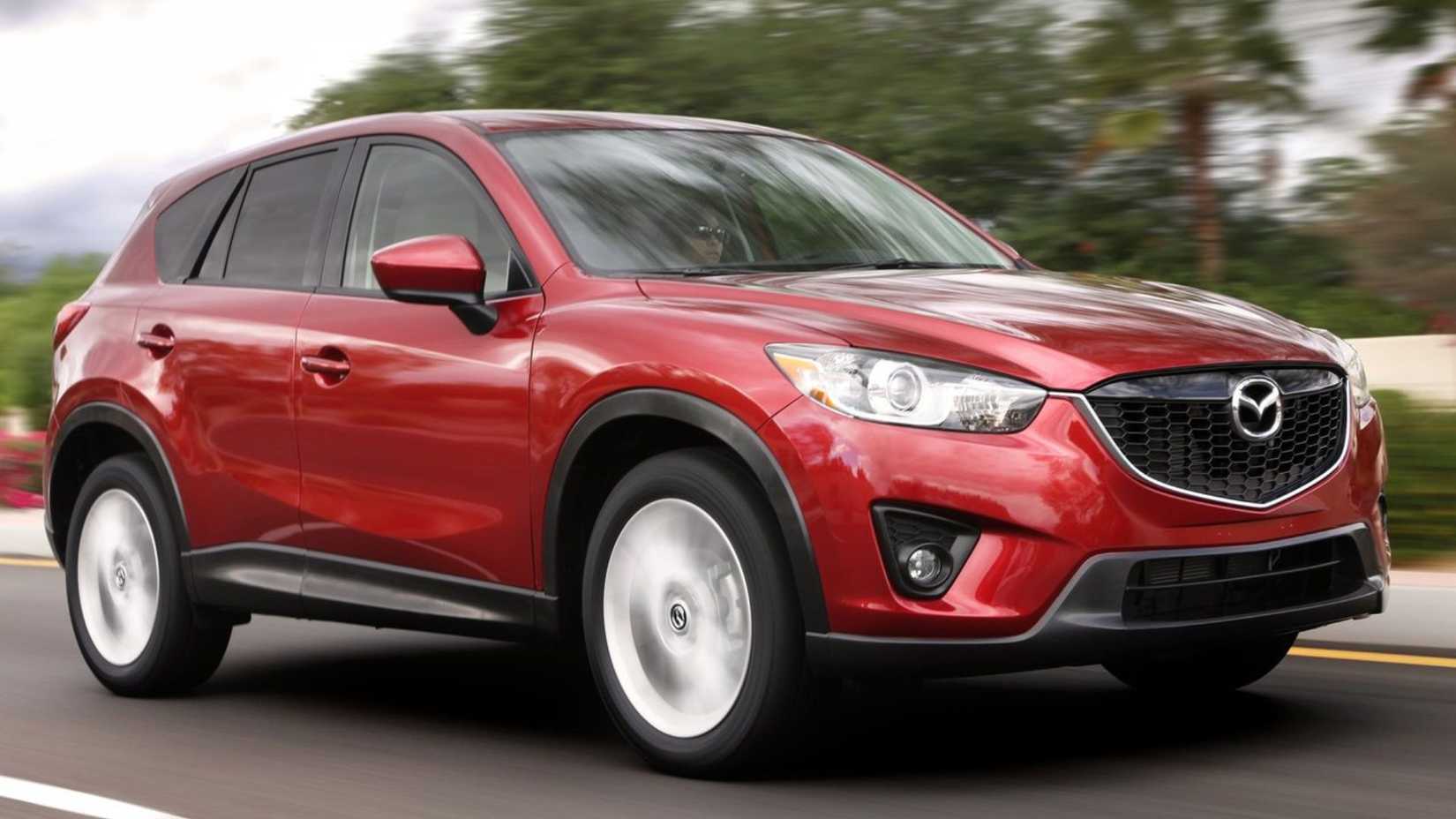Dynamic front 3/4 shot of a red 2013 Mazda CX-5.